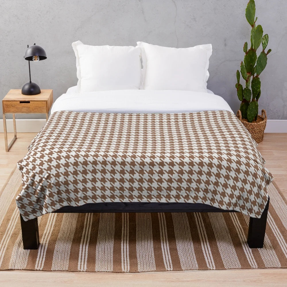 Houndstooth patterned plush blanket in brown and white