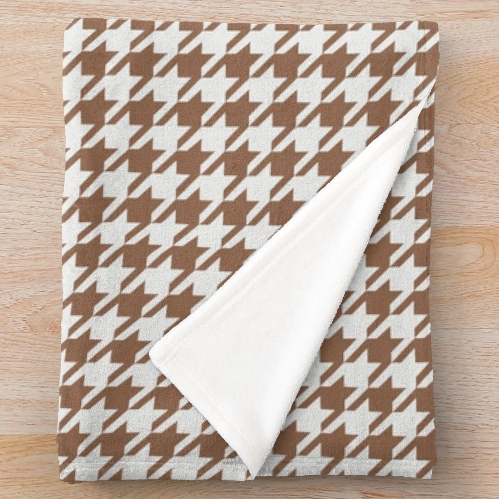 Houndstooth patterned plush blanket in brown and white