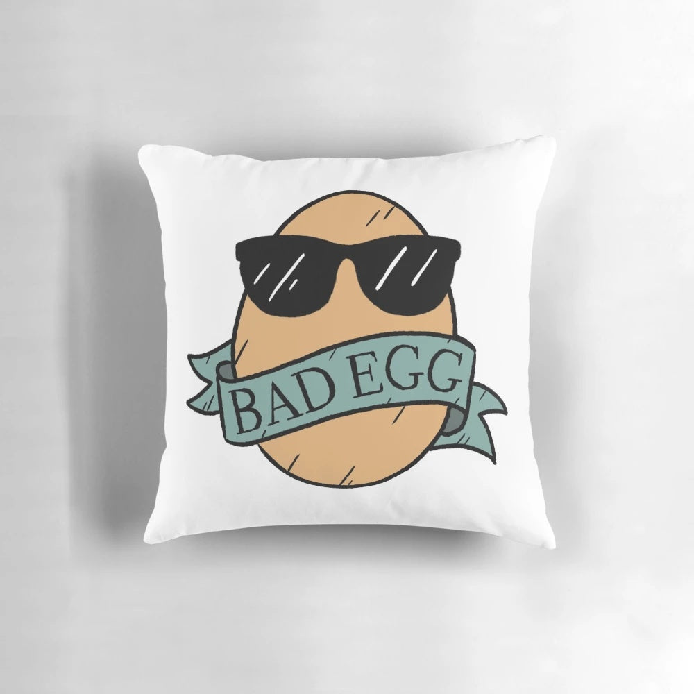 A playful and mischievous bad egg pillow with sunglasses and a banner, perfect for adding a touch of humor and lightheartedness to any room.