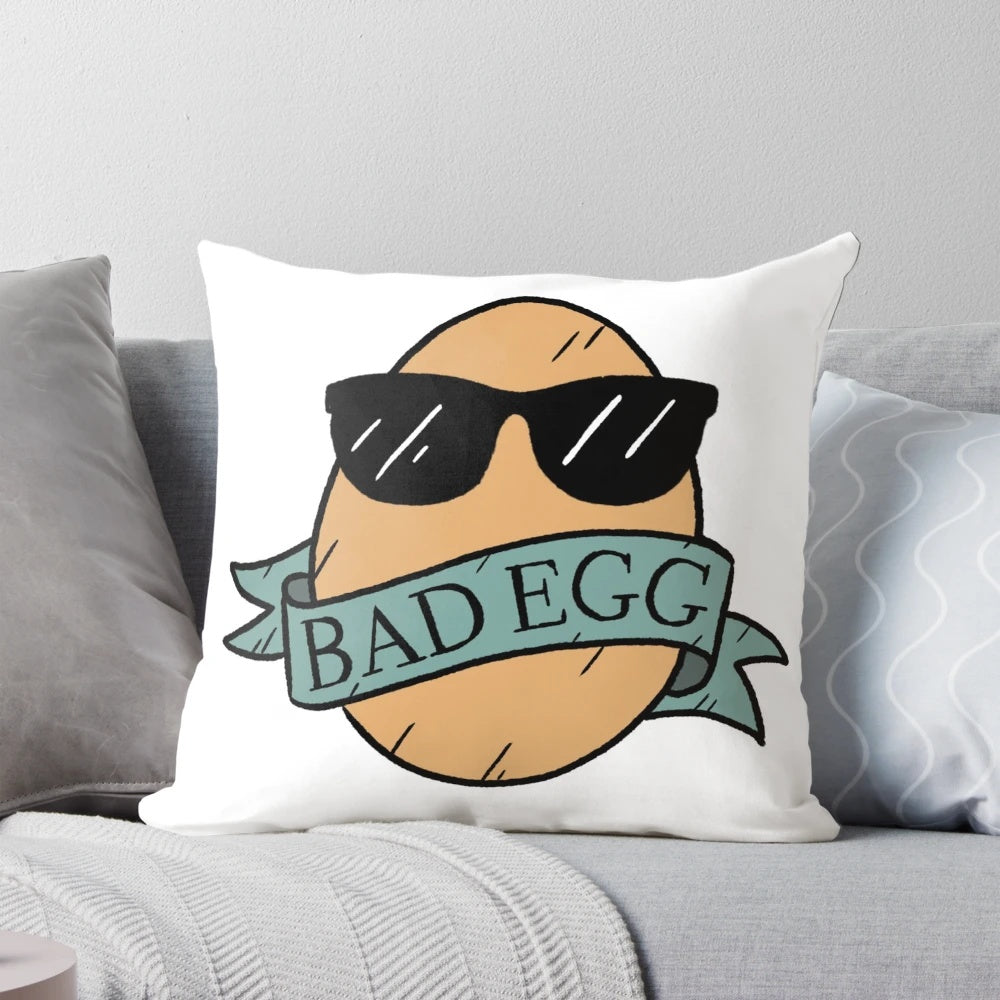 A playful and mischievous bad egg pillow with sunglasses and a banner, perfect for adding a touch of humor and lightheartedness to any room.