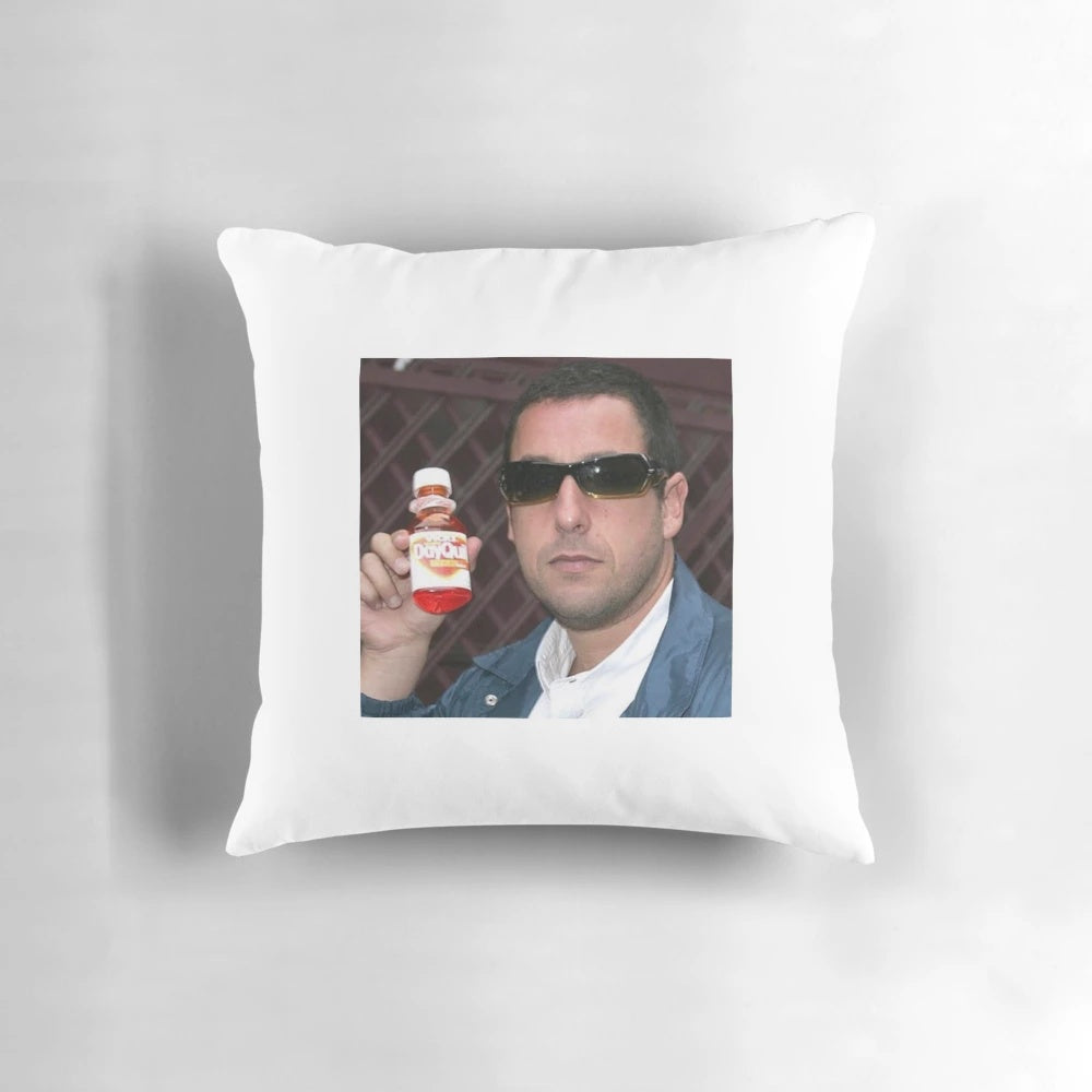 Amusing pillow featuring Adam Sandler's face and "Dayquil" branding
