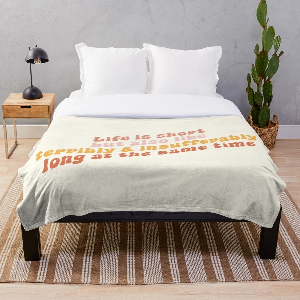 Plush blanket with a humorous message about life's ups and downs