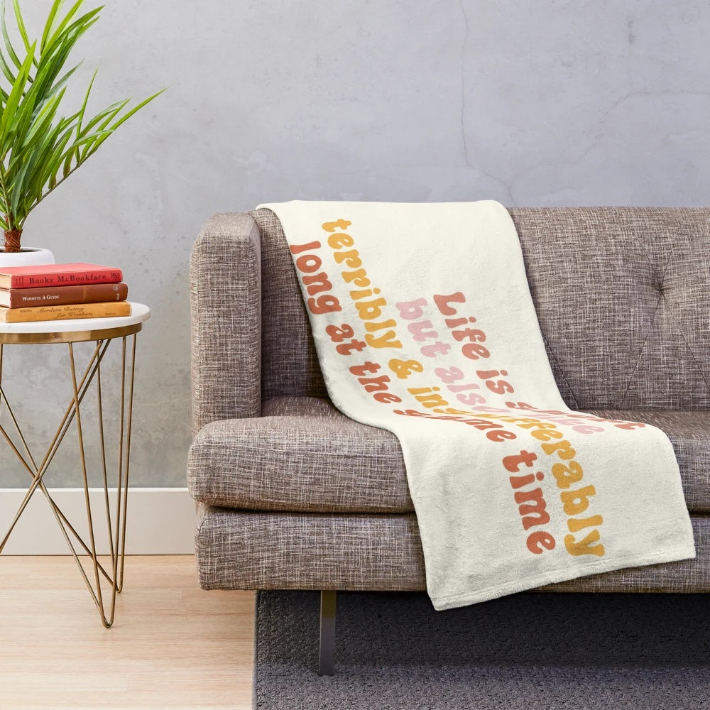 Plush blanket with a humorous message about life's ups and downs