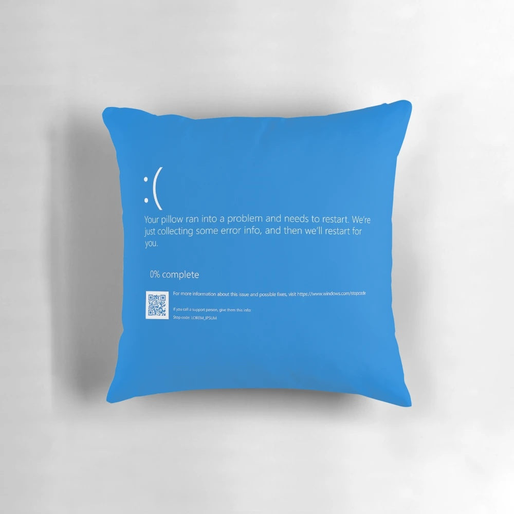 Decorative pillow featuring a playful "Blue Screen of Death" design, a nod to the iconic Windows computer error.