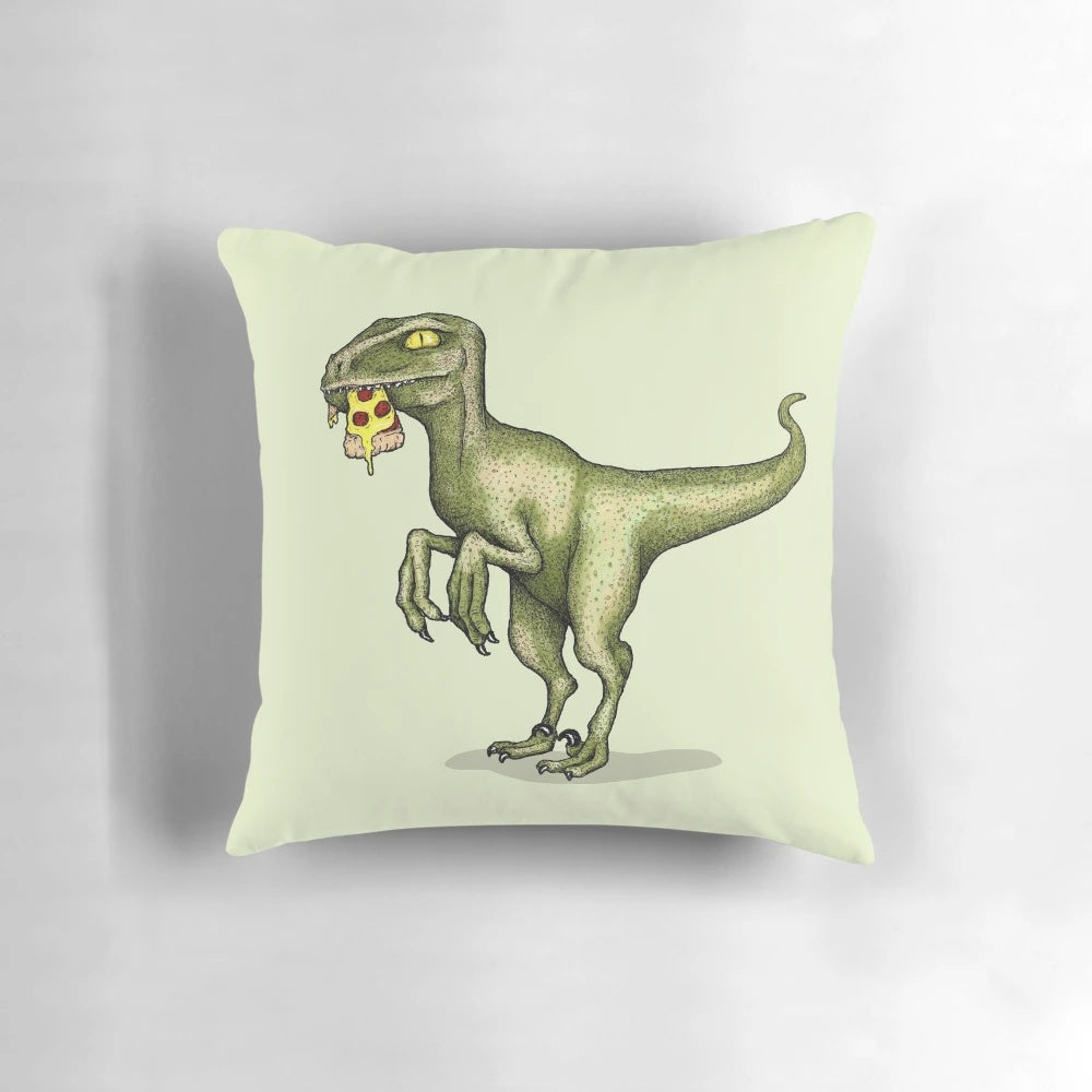 A green raptor dinosaur aggressively eating a slice of pizza on a cozy throw pillow.