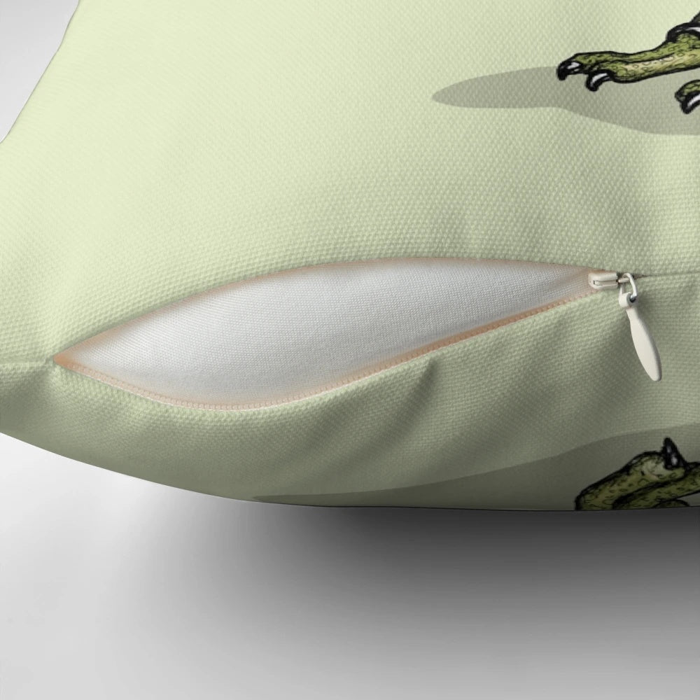 A green raptor dinosaur aggressively eating a slice of pizza on a cozy throw pillow.