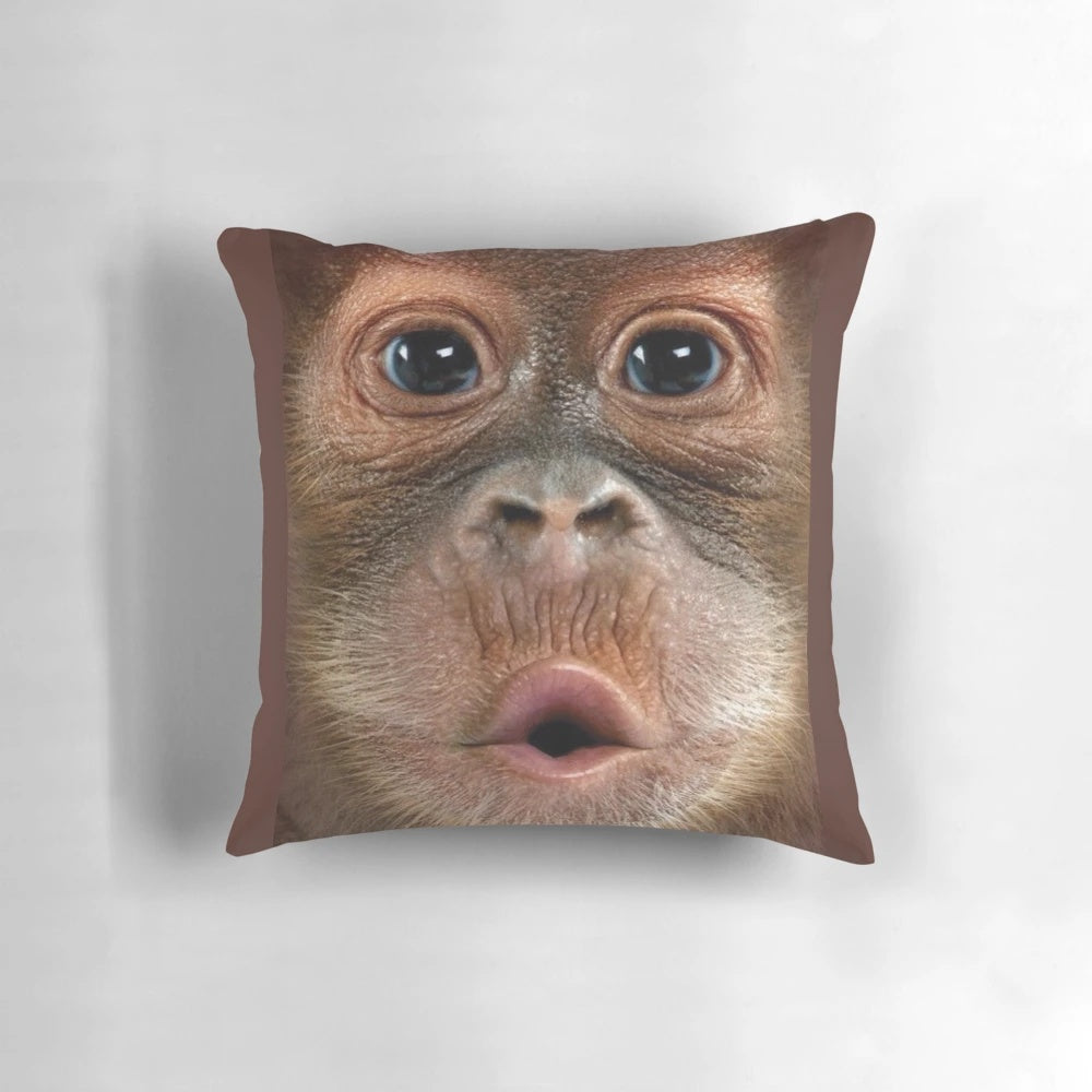 Soft and cuddly hyper-realistic baby orangutan monkey pillow with a big, funny face