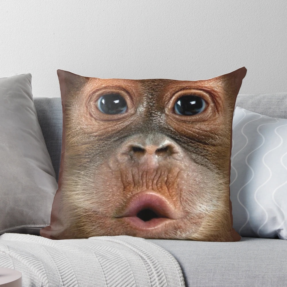 Soft and cuddly hyper-realistic baby orangutan monkey pillow with a big, funny face