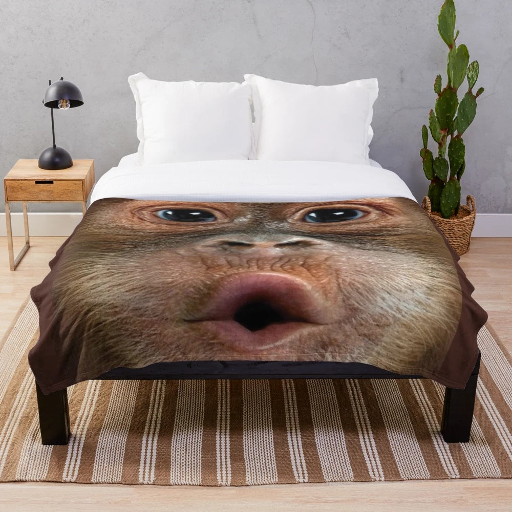 Hyper-realistic plush blanket featuring a funny, shouting monkey design