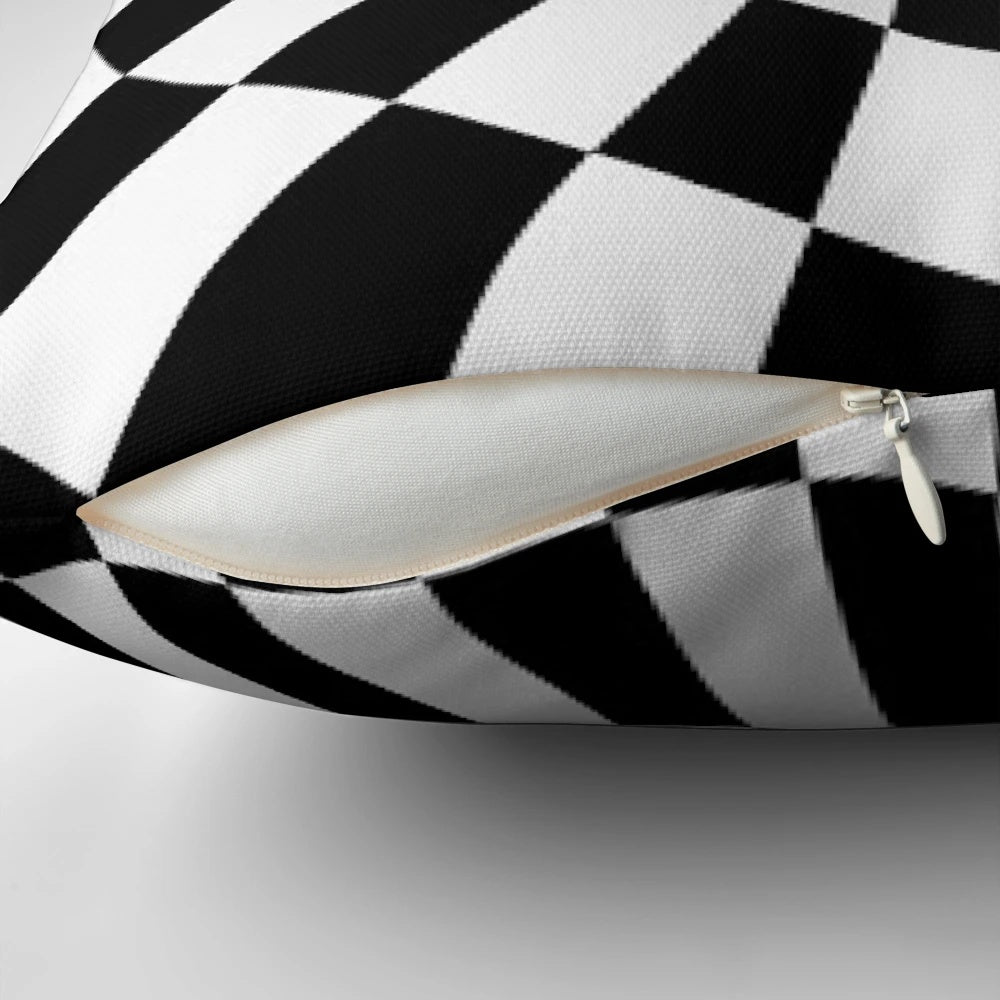 A black and white checkerboard optical illusion pillow, perfect for adding a touch of abstract art to your home.