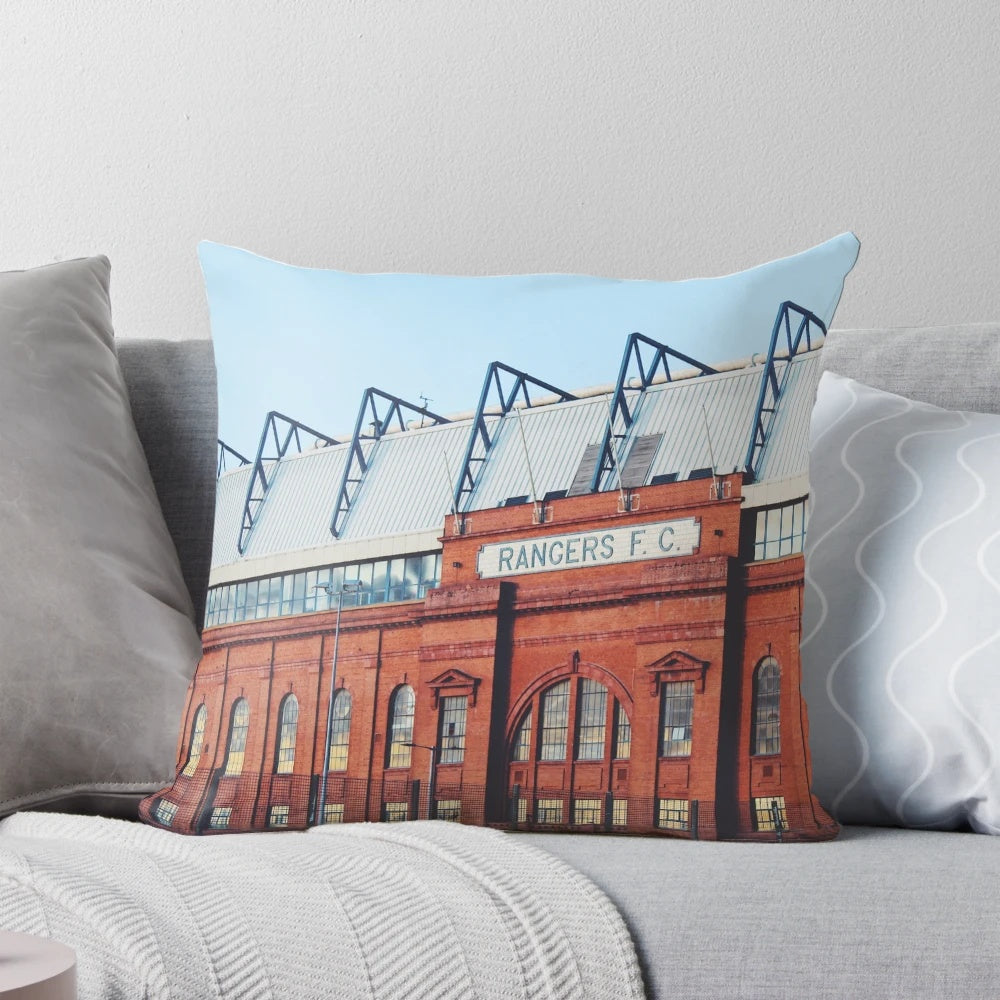 Pillow featuring a photograph of Ibrox Stadium in Glasgow, Scotland at blue hour.