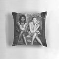 Black and white photograph of 90s supermodels Naomi Campbell and Kate Moss posing together on a pillow.