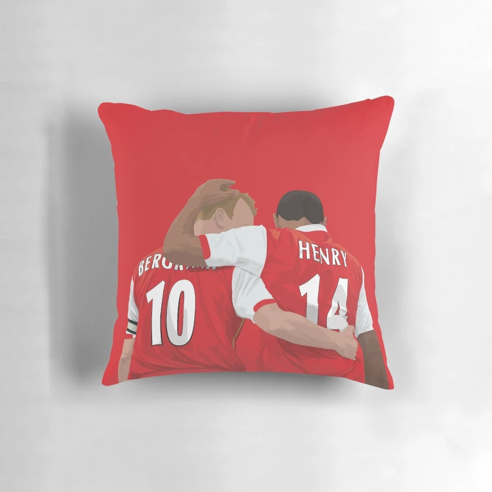 Thierry Henry and Dennis Bergkamp, two renowned Arsenal FC football legends, featured on a decorative pillow.