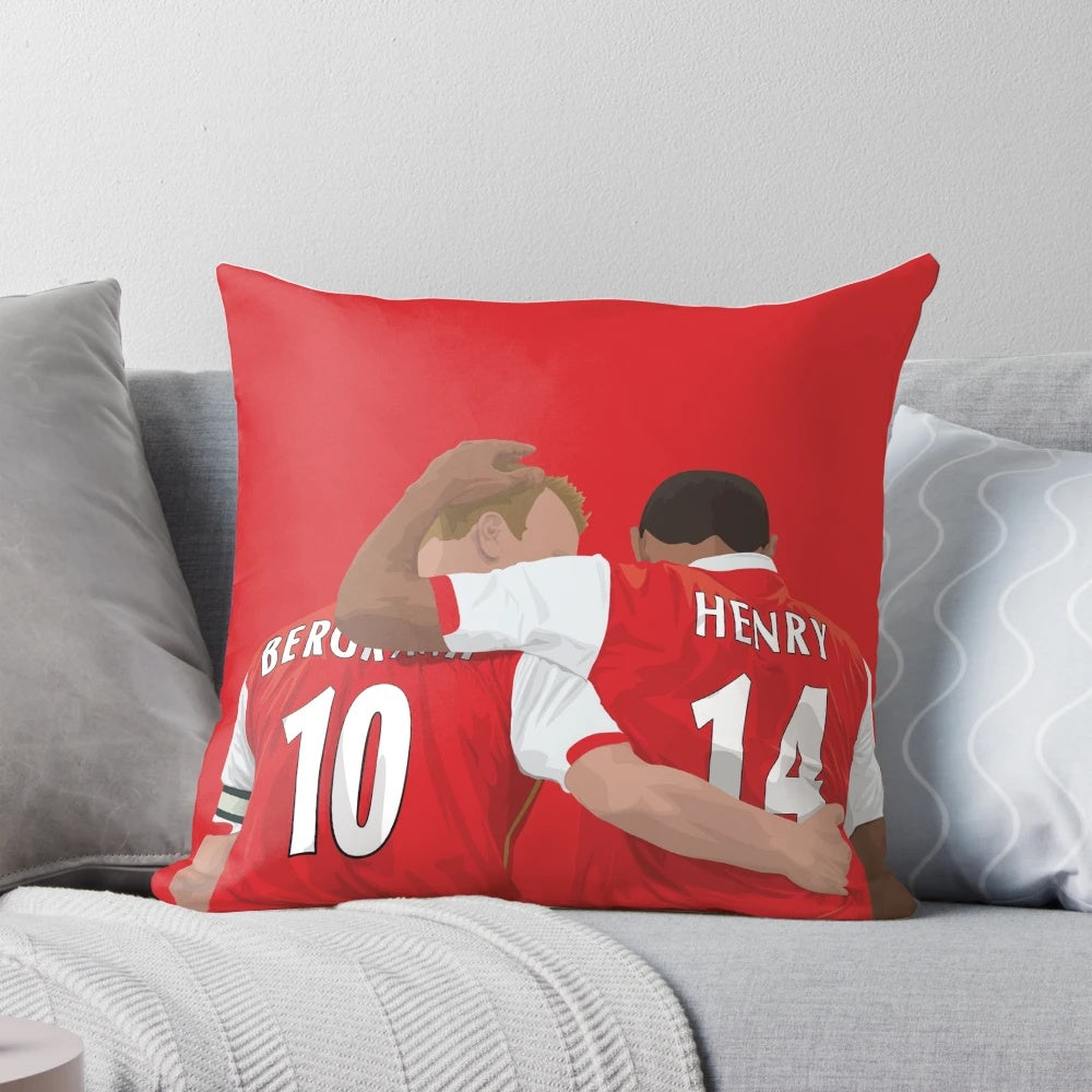 Thierry Henry and Dennis Bergkamp, two renowned Arsenal FC football legends, featured on a decorative pillow.