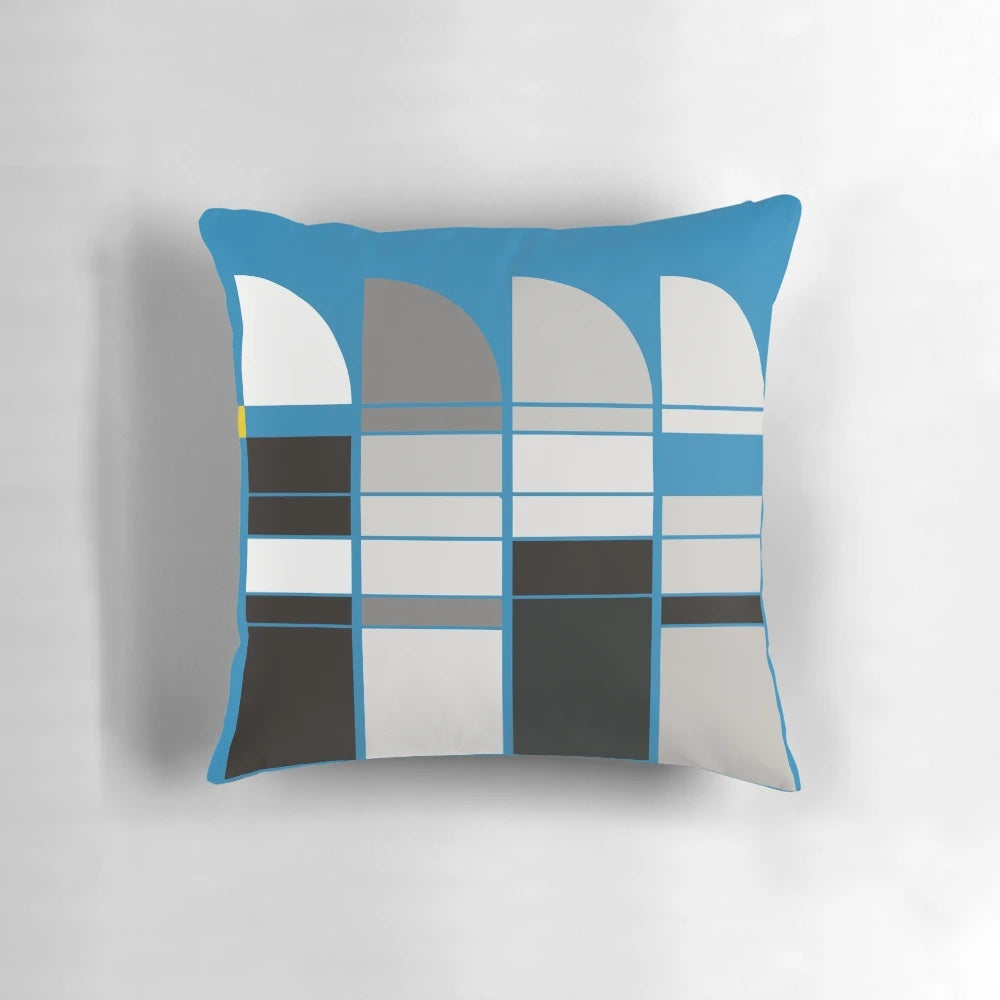 Bauhaus-inspired pillow with abstract blue, grey, and yellow geometric design