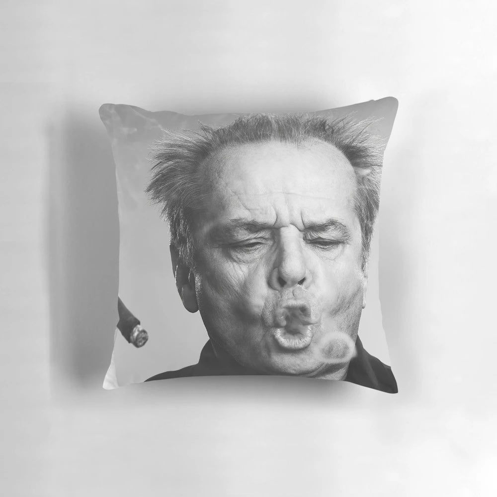 A striking black and white photograph of iconic Hollywood actor Jack Nicholson smoking a cigar and blowing smoke rings.