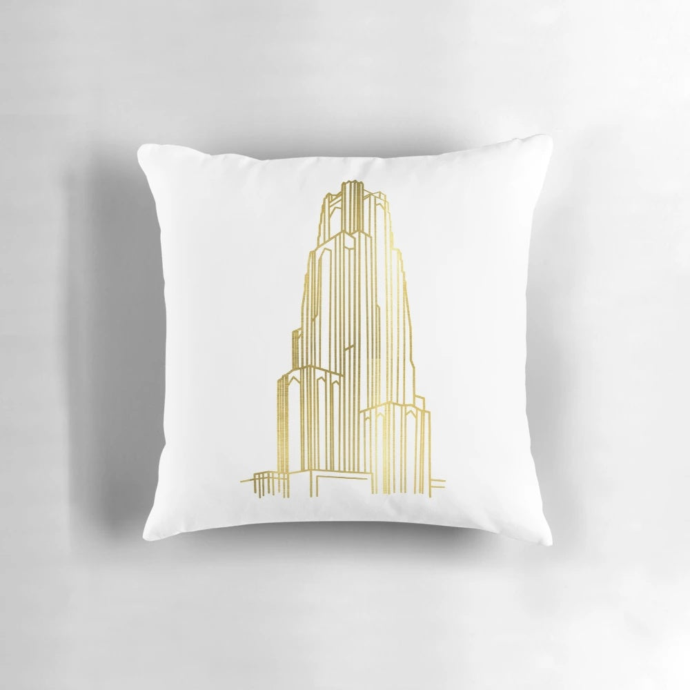 Close-up image of a gold-colored decorative pillow featuring the Cathedral of Learning, a renowned landmark at the University of Pittsburgh.