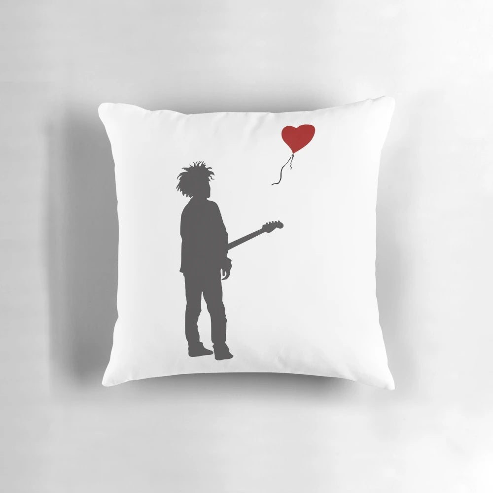 Pillow featuring artwork of the Banksy "Girl with Balloon" design and Robert Smith of The Cure