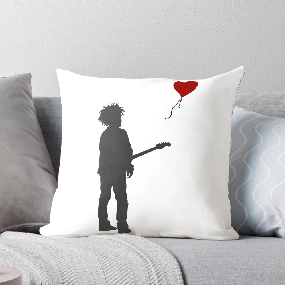Pillow featuring artwork of the Banksy "Girl with Balloon" design and Robert Smith of The Cure