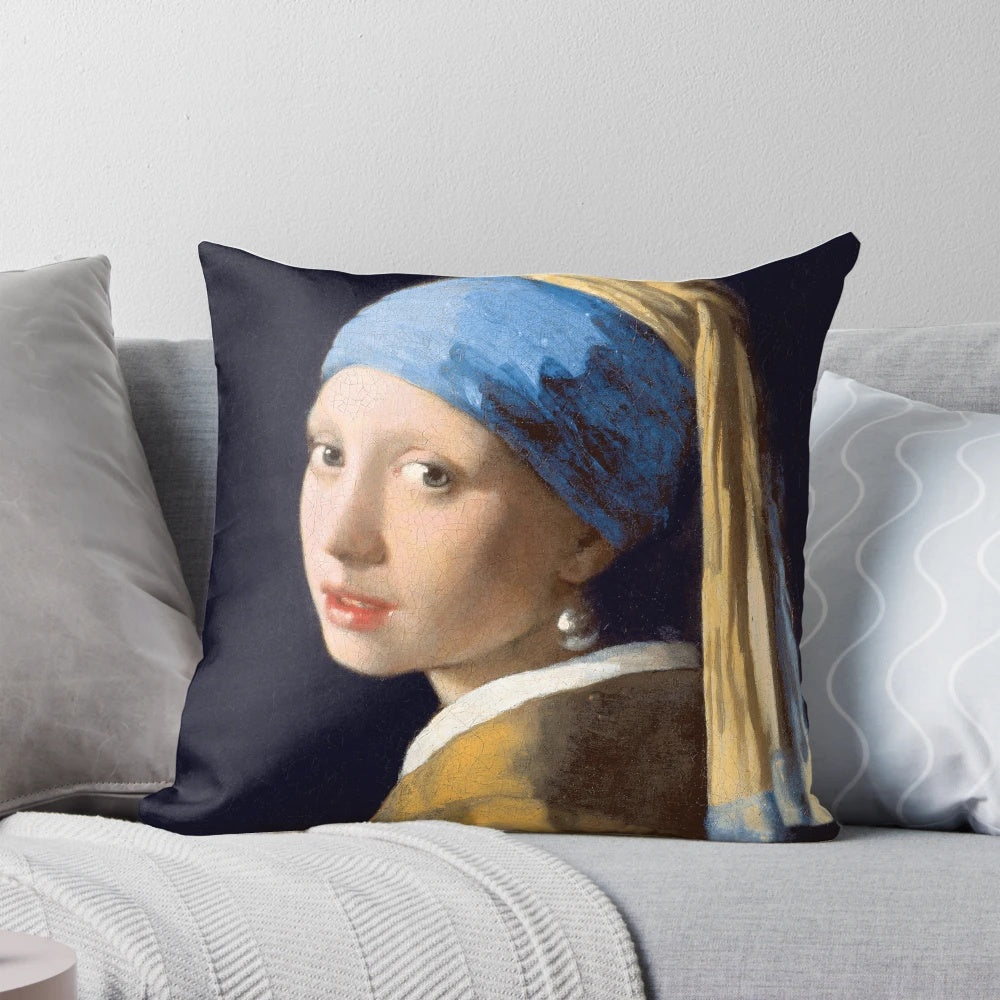 Decorative pillow featuring the famous painting "Girl With A Pearl Earring" by renowned Dutch artist Johannes Vermeer.