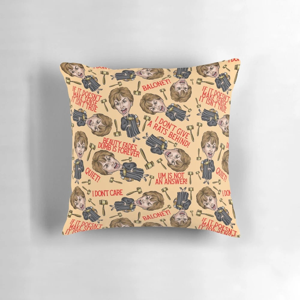 An orange throw pillow featuring a stylized image of TV personality Judge Judy, perfect for pop culture enthusiasts.