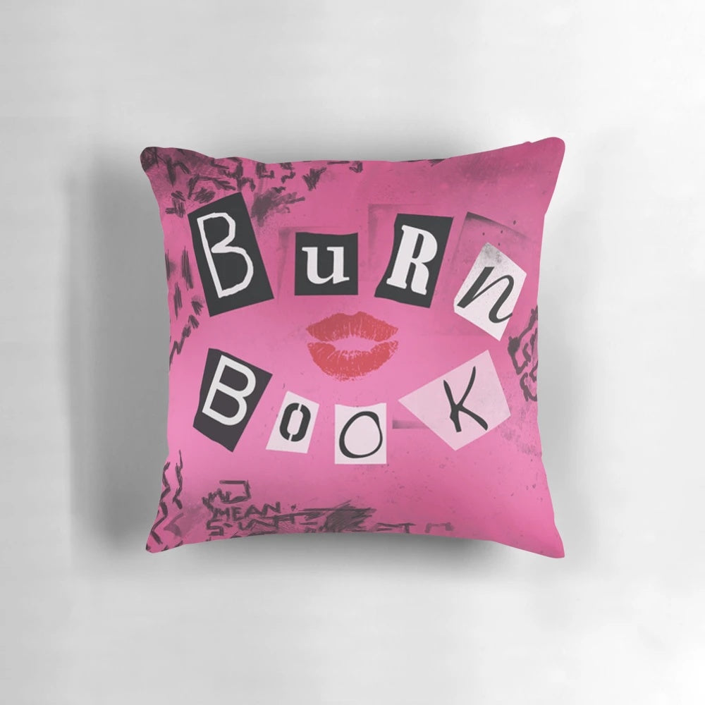 A decorative pillow featuring the iconic "Burn Book" from the classic comedy movie "Mean Girls"