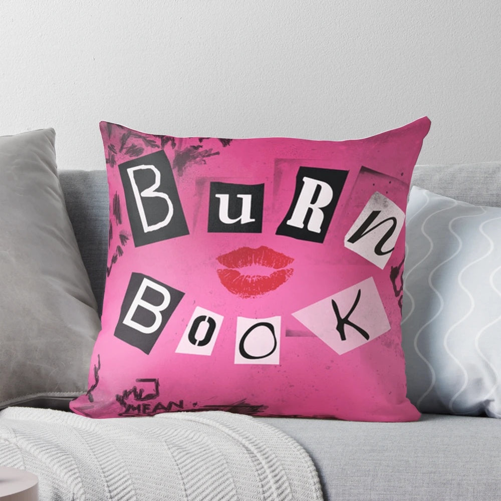 A decorative pillow featuring the iconic "Burn Book" from the classic comedy movie "Mean Girls"