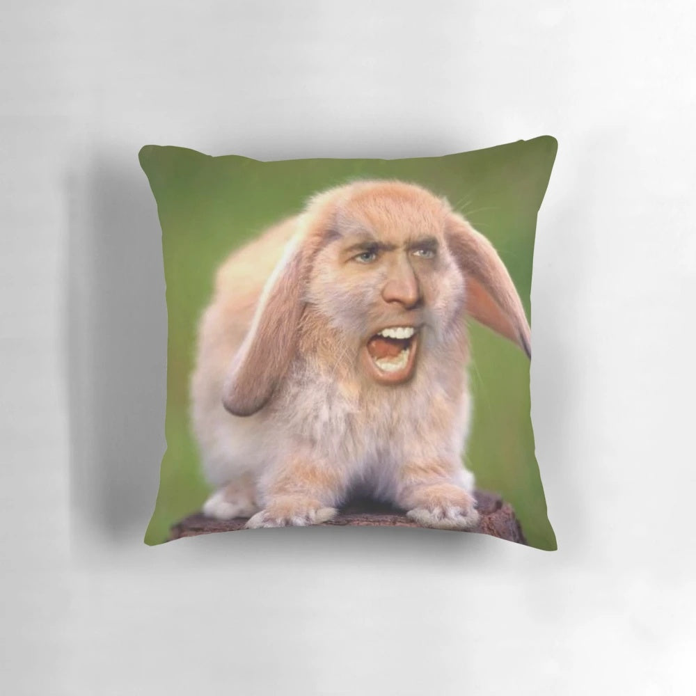 A photoshopped image of a rabbit's face on Nicholas Cage's head, printed on a soft, plush pillow.