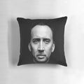 A plush pillow featuring the iconic wide-eyed face of actor Nicolas Cage