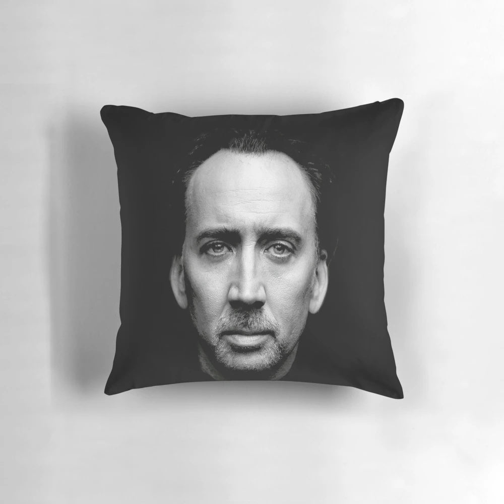 A plush pillow featuring the iconic wide-eyed face of actor Nicolas Cage