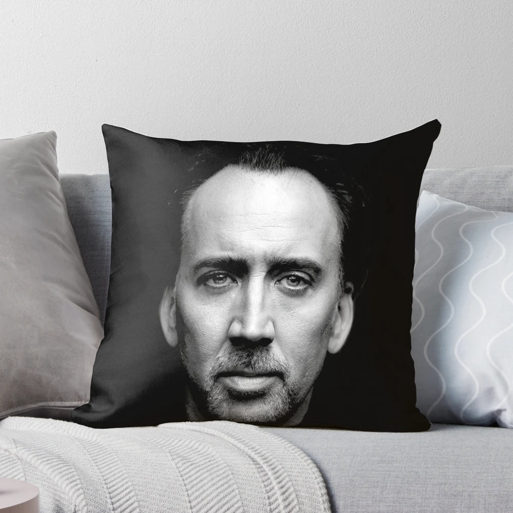 A plush pillow featuring the iconic wide-eyed face of actor Nicolas Cage