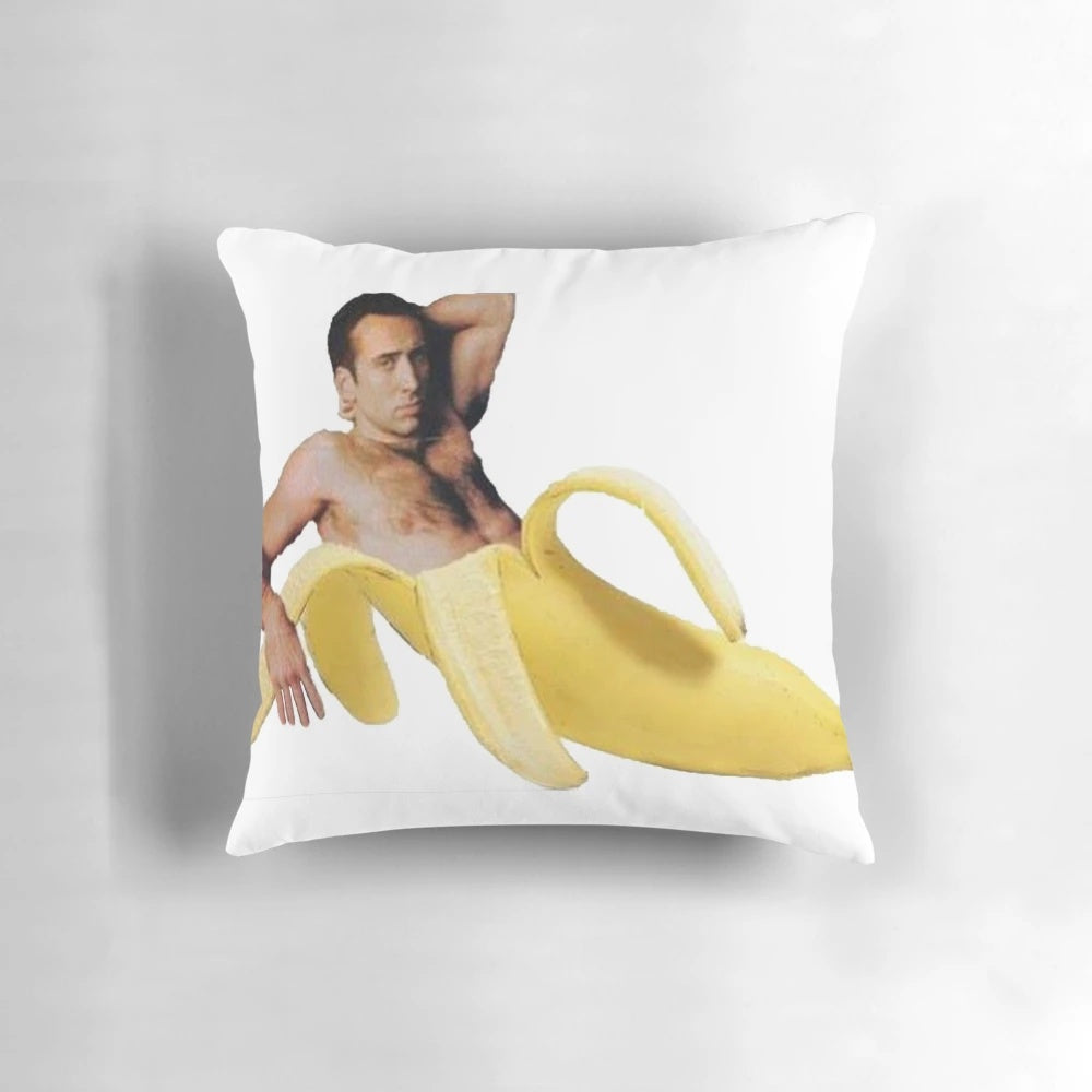 Vibrant yellow pillow depicting the iconic "Nicolas Cage in a Banana" meme image
