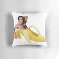 Vibrant yellow pillow depicting the iconic "Nicolas Cage in a Banana" meme image