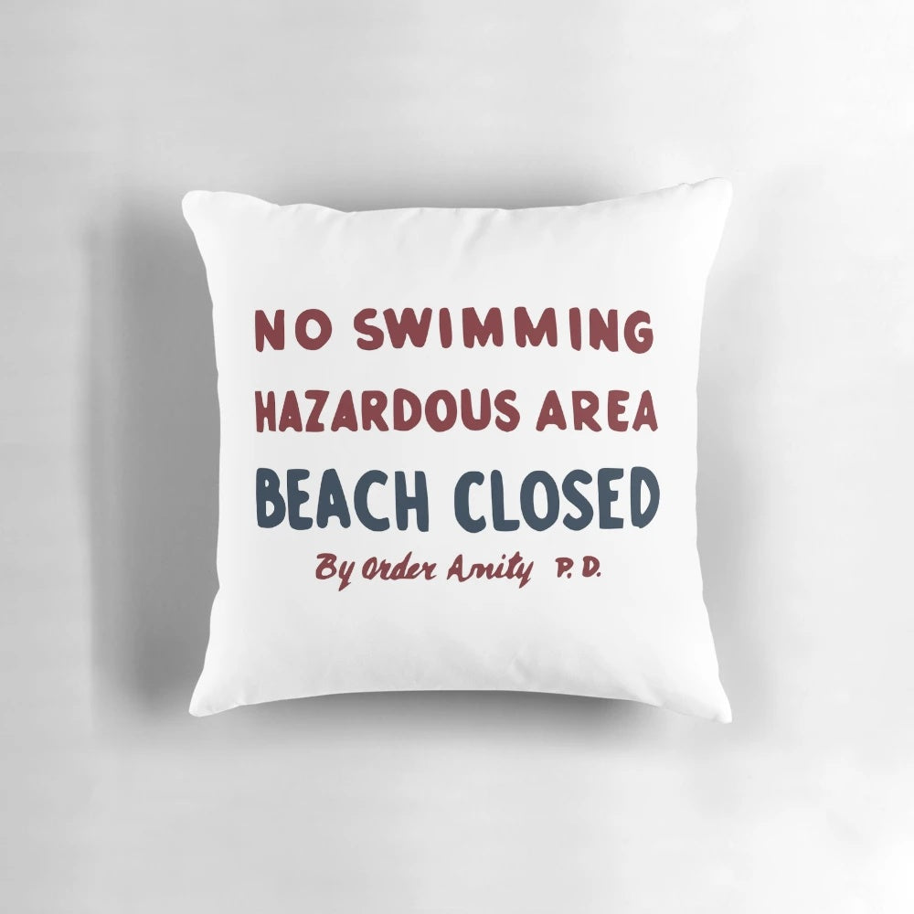 Plush Jaws movie-inspired "No Swimming" sign pillow with vintage shark graphics
