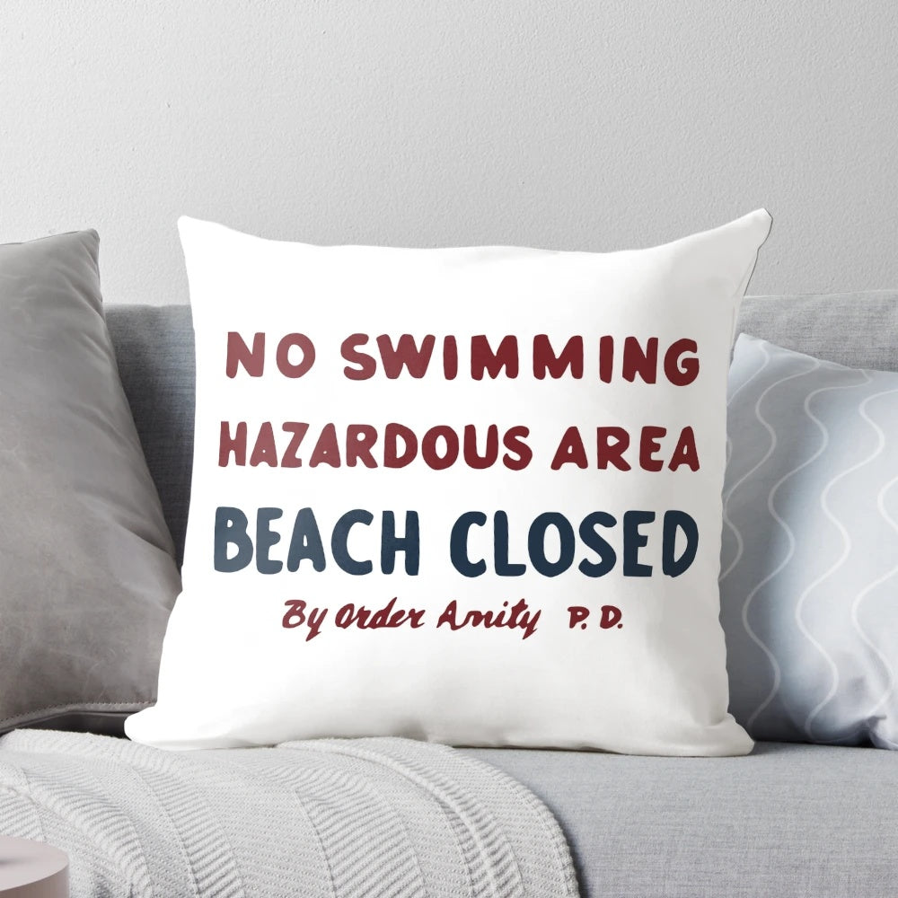 Plush Jaws movie-inspired "No Swimming" sign pillow with vintage shark graphics