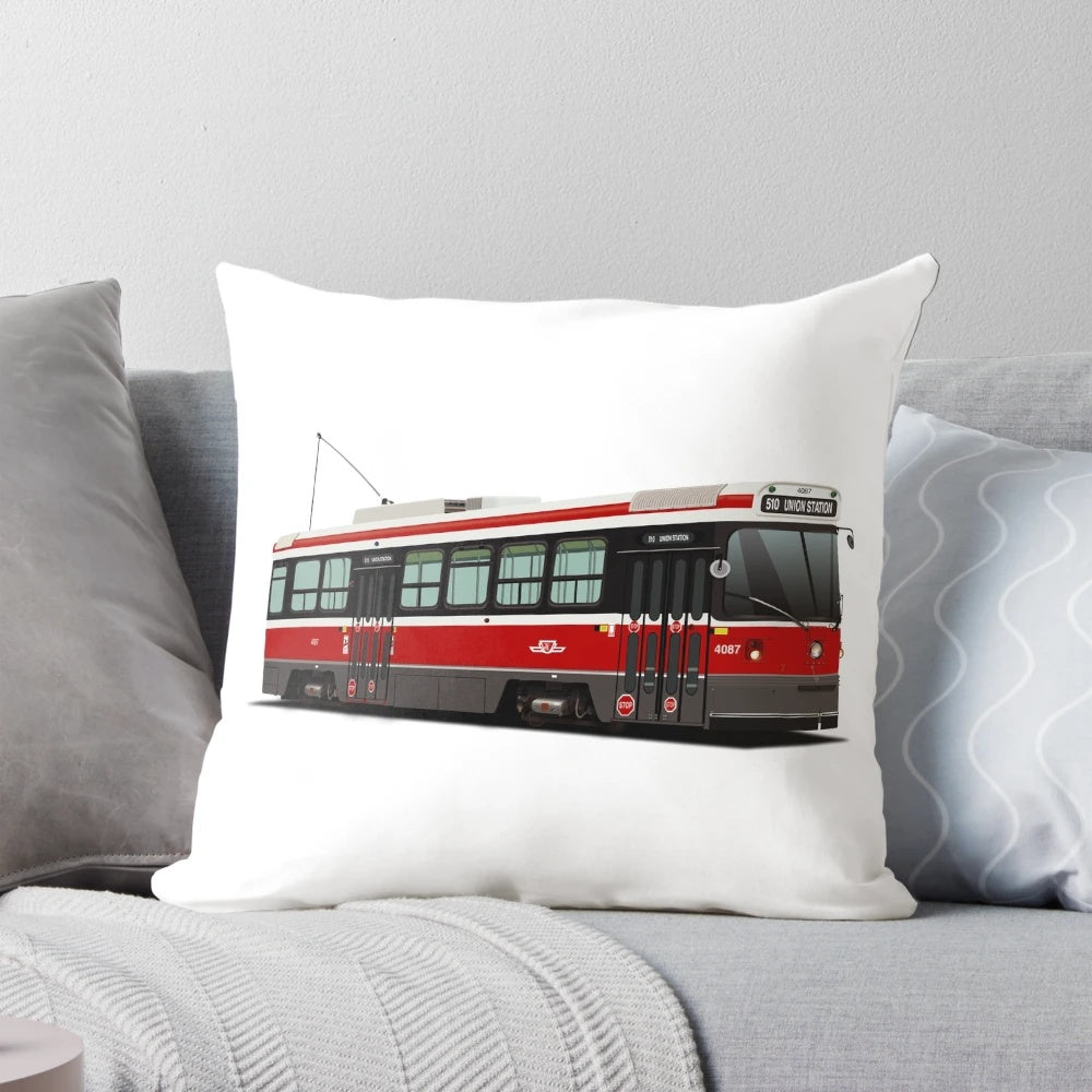 Pillow featuring an illustration of a classic Toronto streetcar in red, white, and grey.