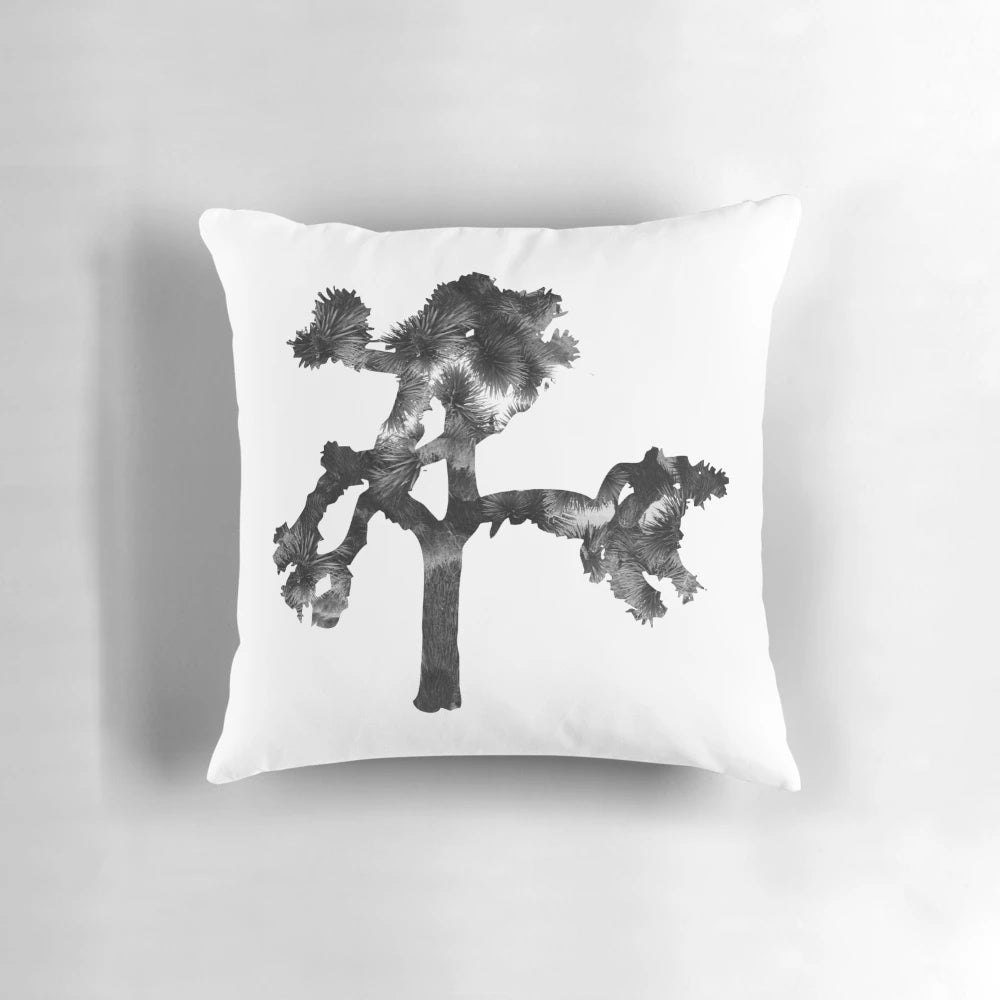 A cozy pillow featuring a tree-shaped design, inspired by the iconic album cover of U2's "The Joshua Tree