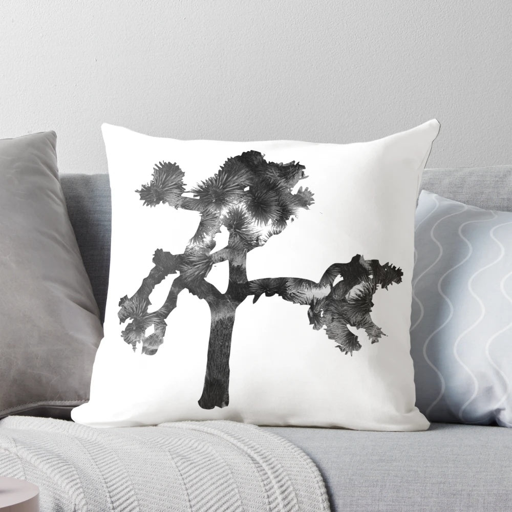 A cozy pillow featuring a tree-shaped design, inspired by the iconic album cover of U2's "The Joshua Tree