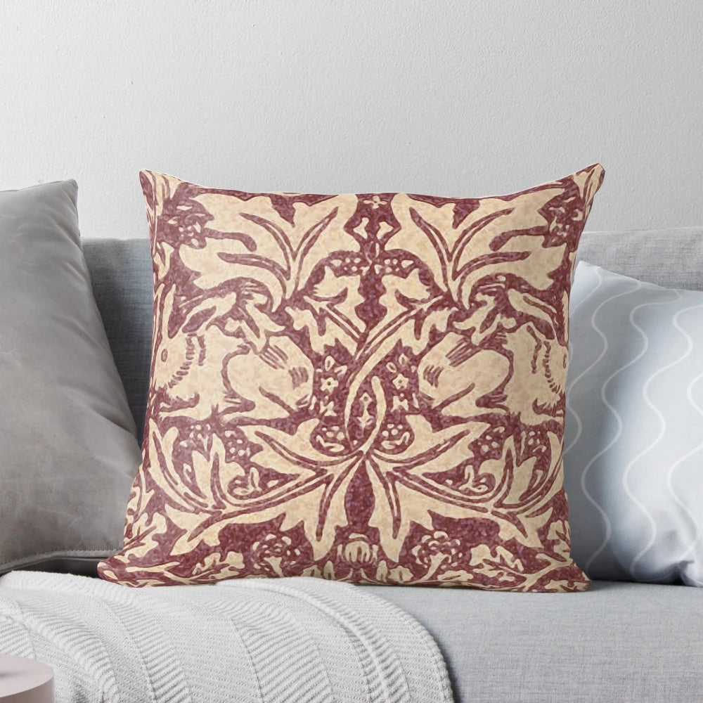 Burgundy patterned pillow with William Morris' iconic Brer Rabbit design