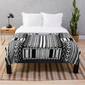 Ifugao-inspired black and white plush blanket with unique tribal patterns