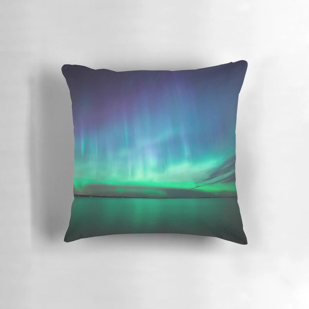 Stunning pillow featuring the captivating northern lights (aurora borealis) in a night sky landscape.