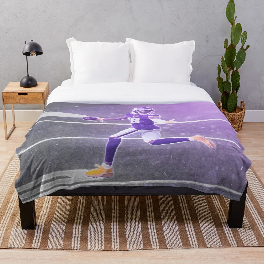 Illustration of Justin Jefferson in a purple and yellow plush blanket