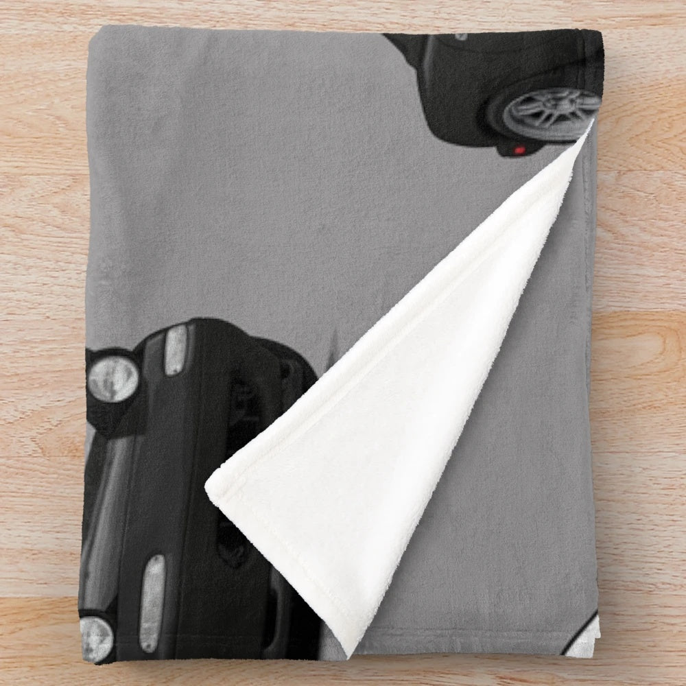 Illustration of a Mazda MX-5 Miata NA MK1 on a plush blanket