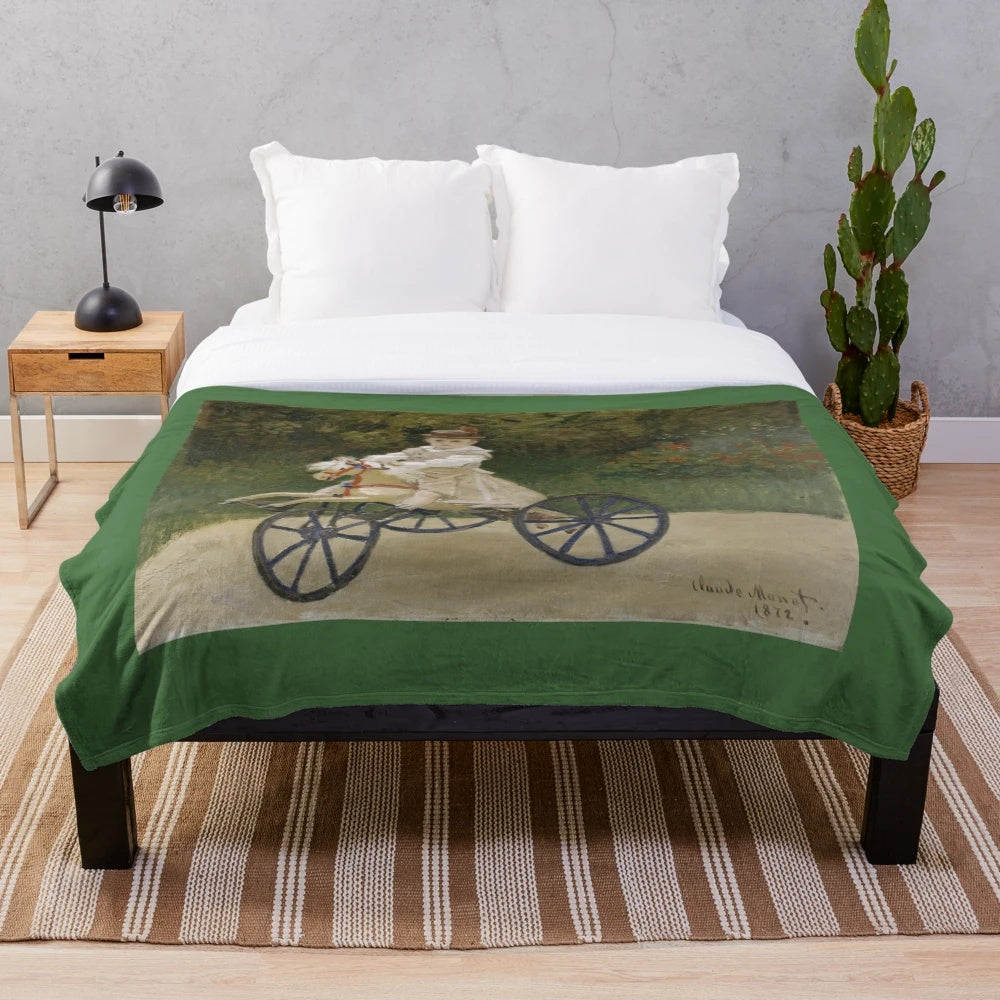 Plush blanket featuring the impressionist painting "Jean Monet on his Hobby Horse" by Claude Monet