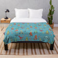 Inclusive dinosaur plush blanket featuring dinosaurs with mobility devices