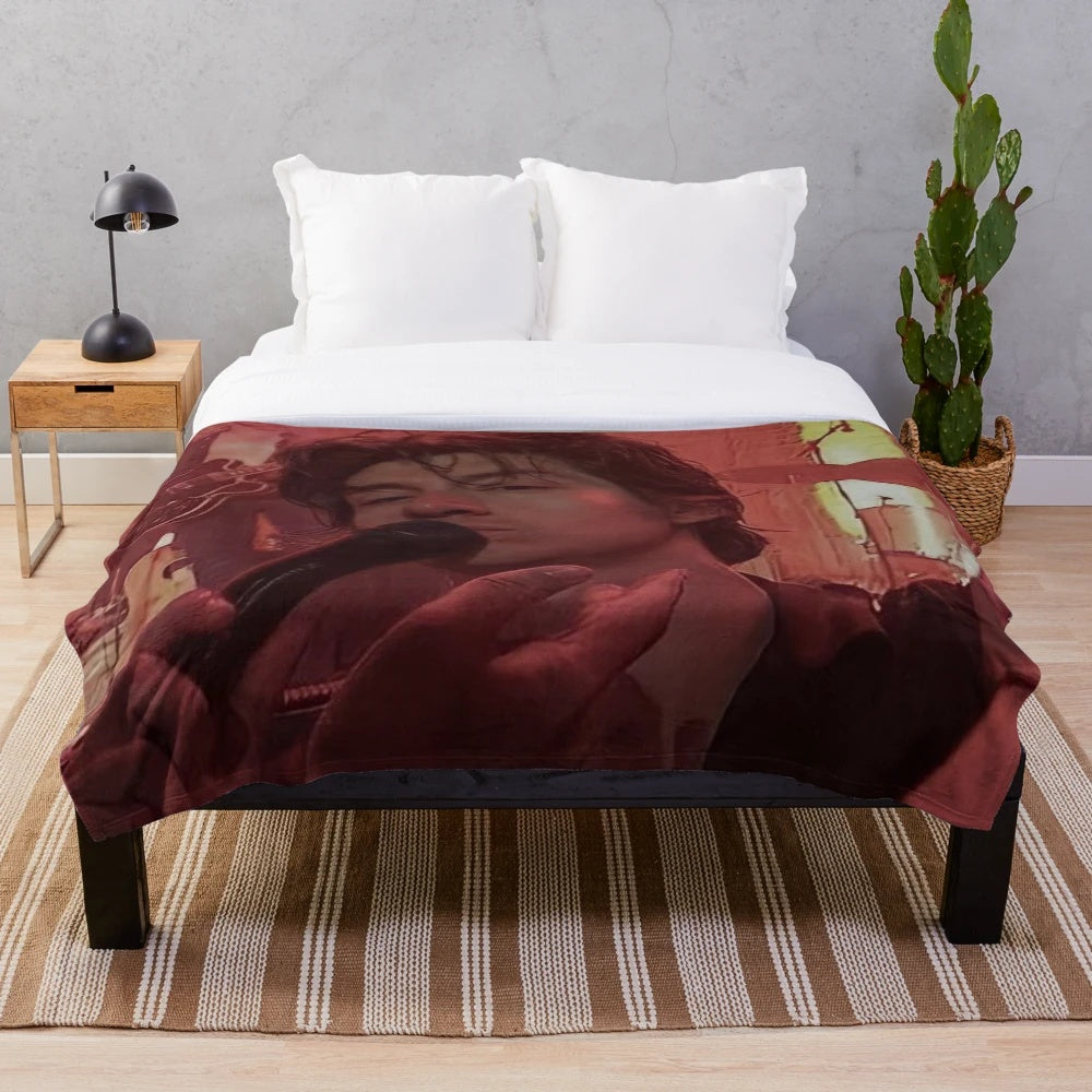 Cozy plush blanket featuring an artistic design inspired by indie rock band Arctic Monkeys and frontman Alex Turner