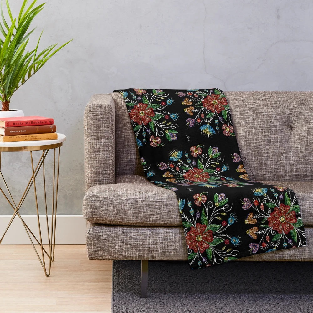 Indigenous-inspired plush blanket with beadwork and dot patterns