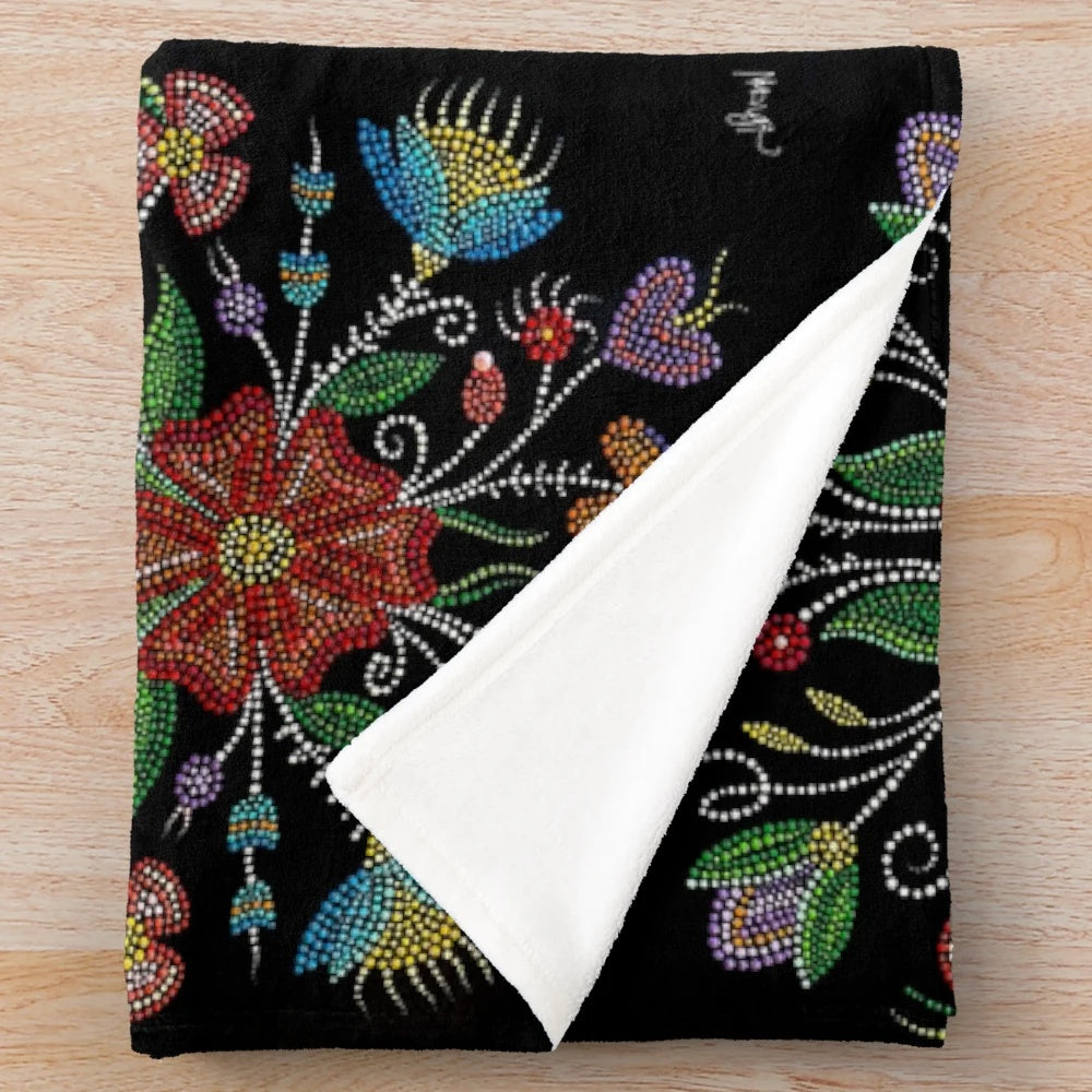 Indigenous-inspired plush blanket with beadwork and dot patterns