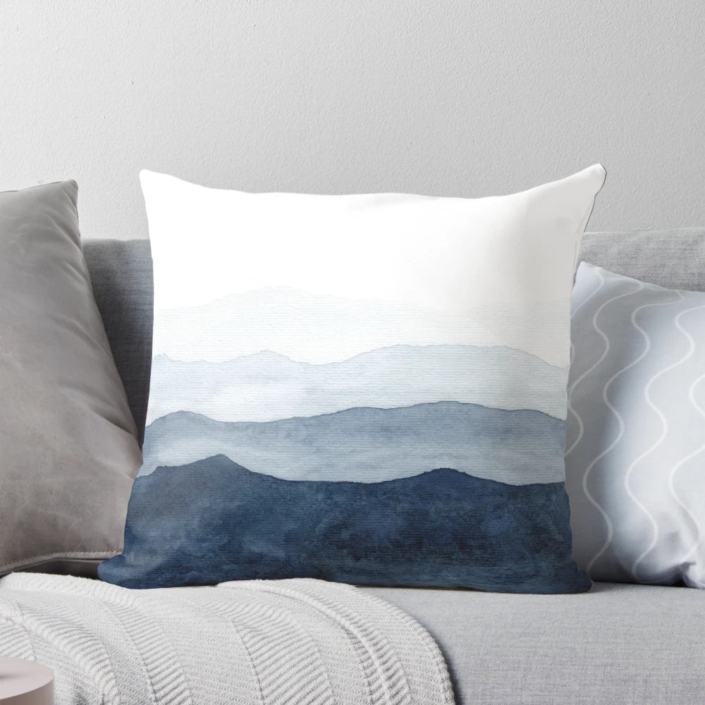 Indigo and blue watercolor abstract mountain landscape design on a modern decorative throw pillow