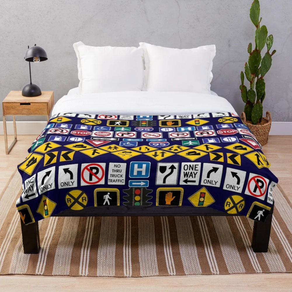 Road signs and traffic regulation symbols printed on a soft, plush blanket